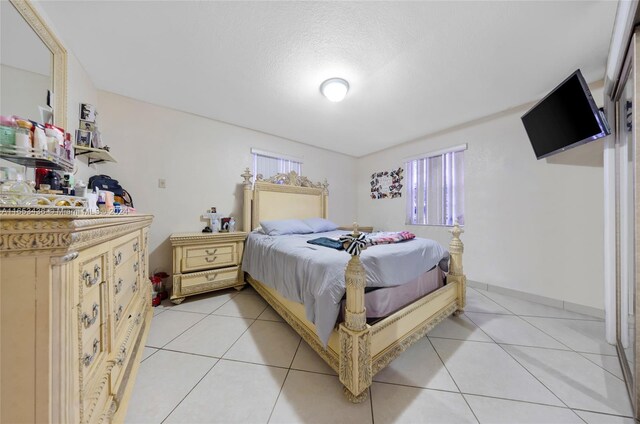 bedroom featuring a textured ceiling and light tile patterned flooring