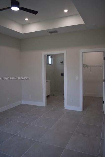 empty room featuring baseboards, visible vents, a ceiling fan, dark tile patterned flooring, and recessed lighting