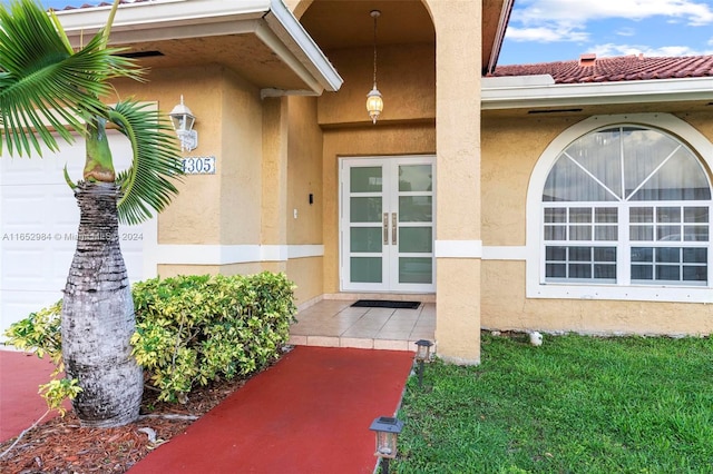 doorway to property featuring a lawn and french doors