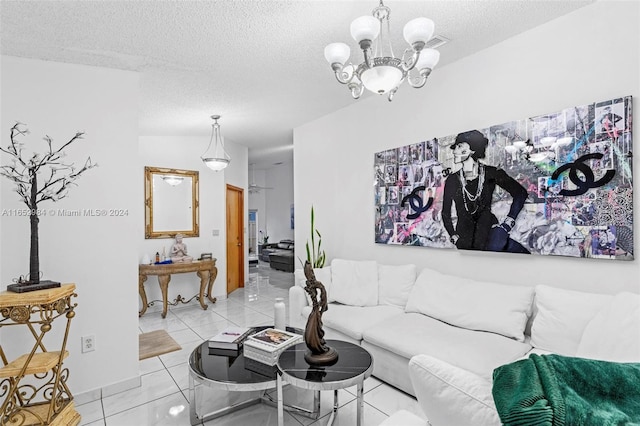 tiled living room featuring a textured ceiling and a notable chandelier