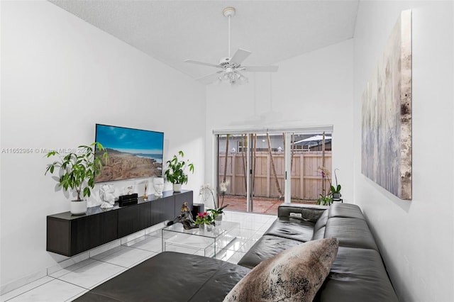 living room featuring high vaulted ceiling, ceiling fan, and a textured ceiling