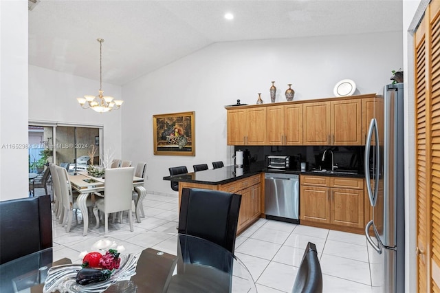 kitchen featuring a notable chandelier, sink, hanging light fixtures, appliances with stainless steel finishes, and light tile patterned flooring