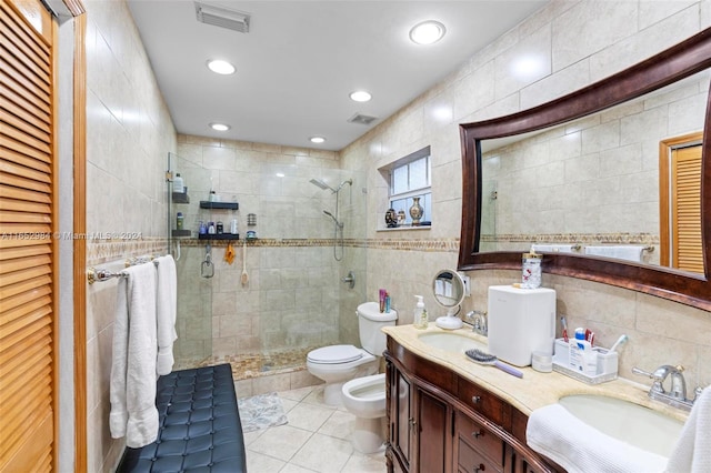 bathroom featuring tile walls, a shower with shower door, toilet, and vanity