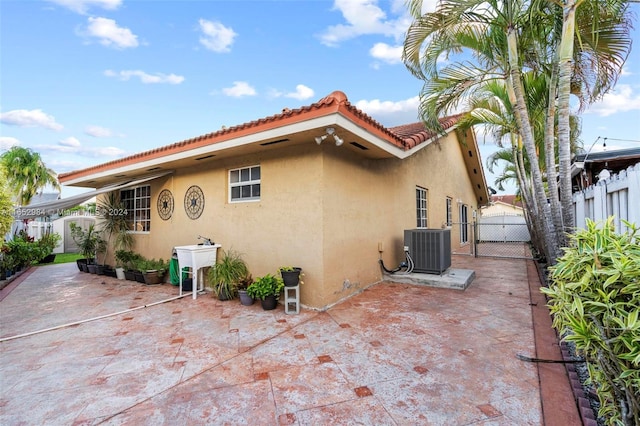 view of home's exterior with a patio and central AC