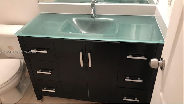 details featuring tile patterned flooring, toilet, and vanity