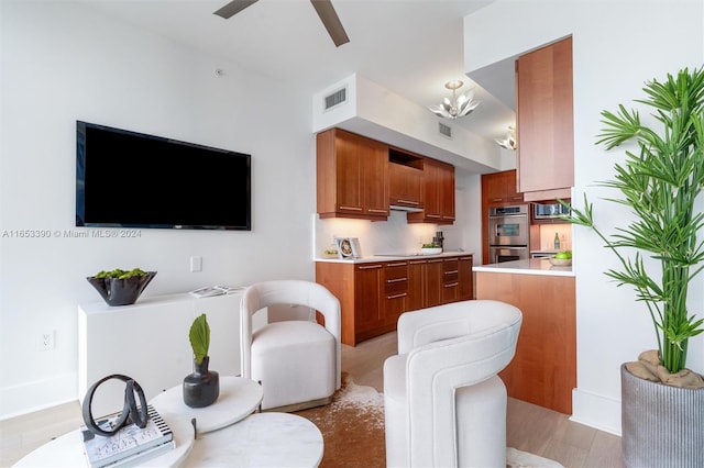 living room with light hardwood / wood-style floors and ceiling fan