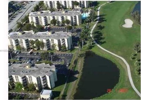 birds eye view of property featuring a view of city and a water view