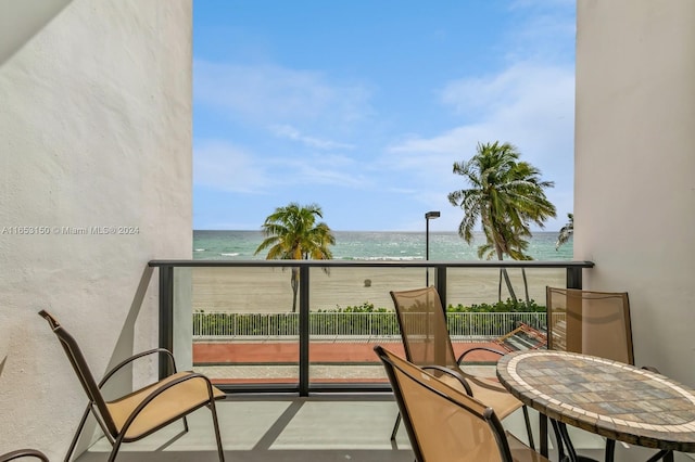 balcony with a view of the beach and a water view