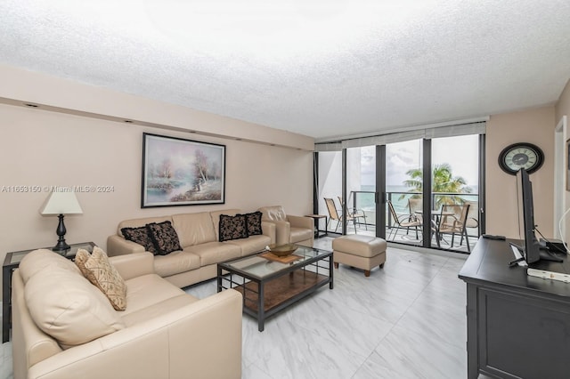 living room featuring a textured ceiling and a wall of windows