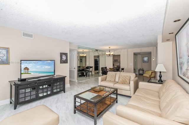 living room with a textured ceiling and a chandelier