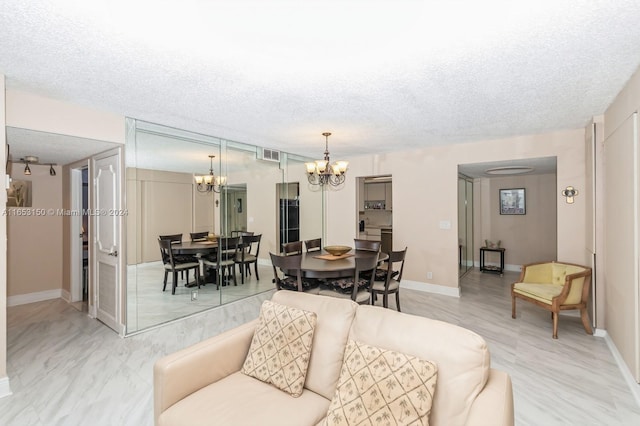 living room with a textured ceiling and an inviting chandelier