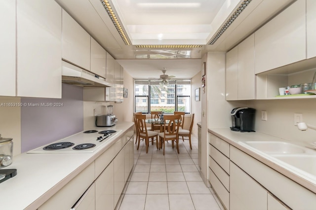 kitchen featuring white cabinetry, light tile patterned flooring, ceiling fan, and white electric stovetop