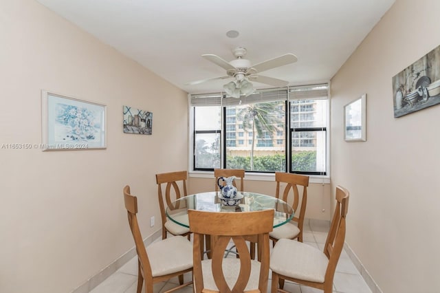 dining space featuring ceiling fan and light tile patterned flooring