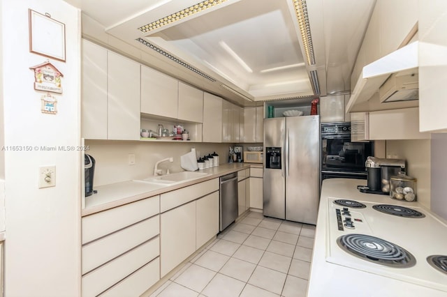 kitchen featuring sink, light tile patterned floors, and appliances with stainless steel finishes