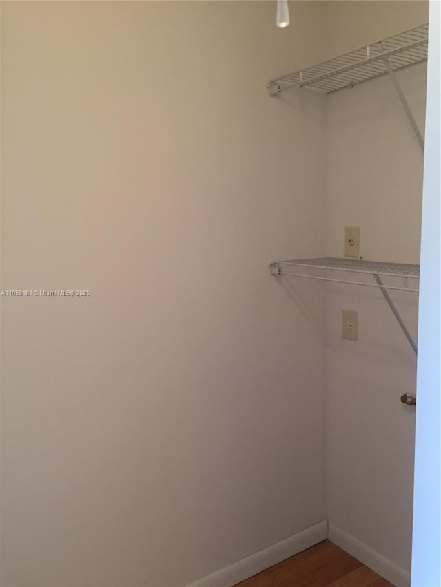 spacious closet featuring hardwood / wood-style flooring