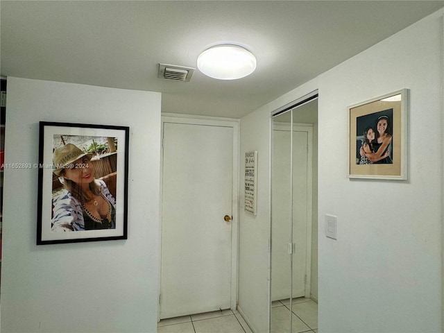 corridor featuring light tile patterned flooring