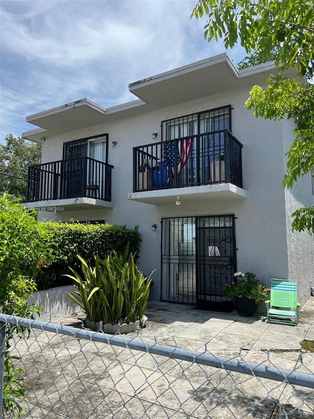 rear view of property featuring a balcony