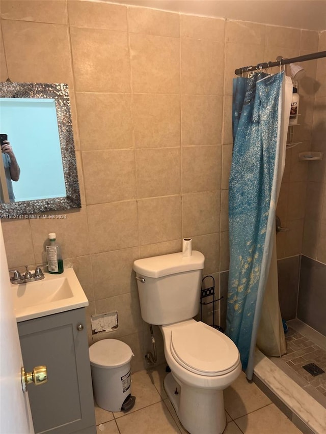 bathroom featuring vanity, tile walls, a shower with shower curtain, and toilet