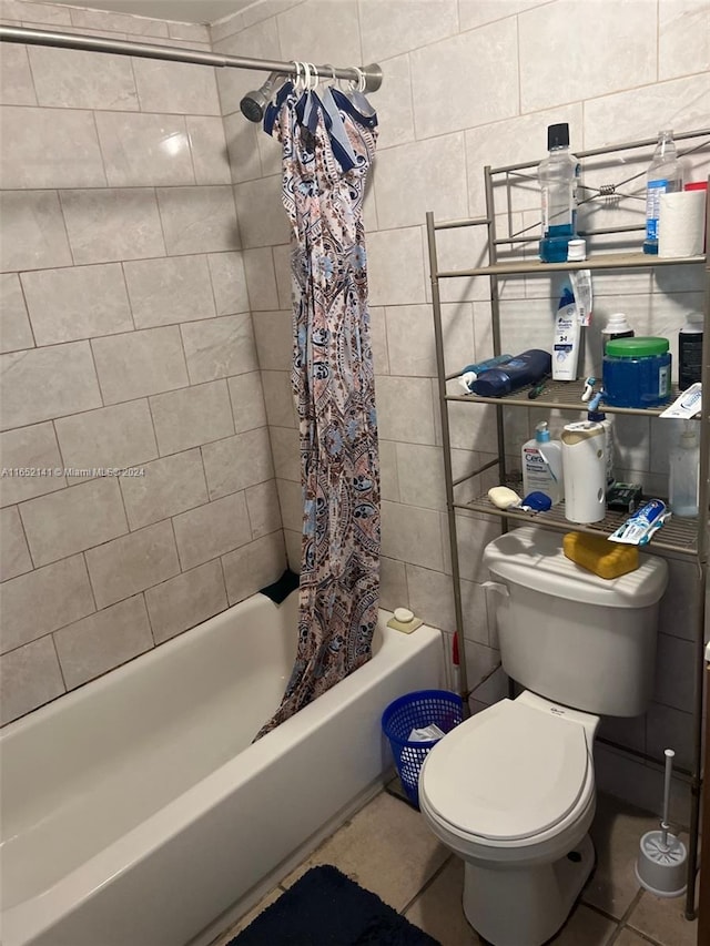 bathroom featuring tile walls, toilet, tile patterned floors, and shower / bath combo