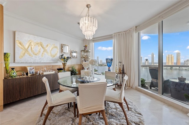 dining area featuring ornamental molding, a water view, a chandelier, and a wall of windows