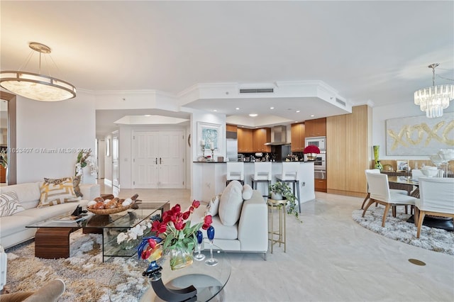 living room with a notable chandelier and crown molding