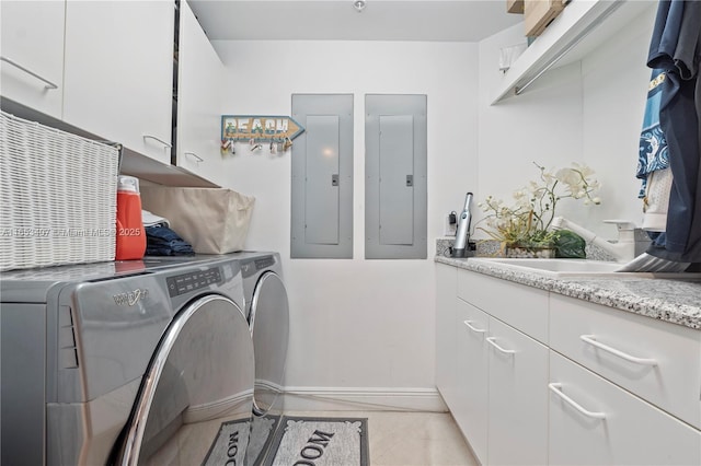 washroom with sink, washer and clothes dryer, electric panel, and cabinets