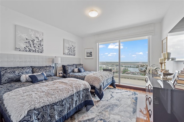 bedroom with hardwood / wood-style flooring and access to exterior