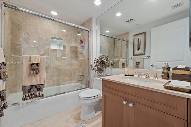 full bathroom featuring tile patterned flooring, vanity, toilet, and combined bath / shower with glass door