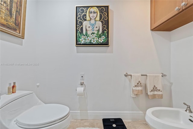 bathroom featuring a bidet, tile patterned flooring, and toilet