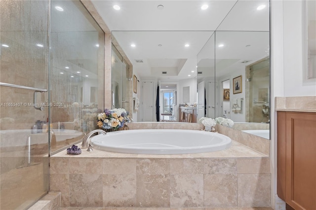 bathroom featuring independent shower and bath and vanity