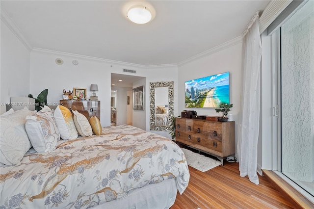 bedroom with crown molding and light wood-type flooring