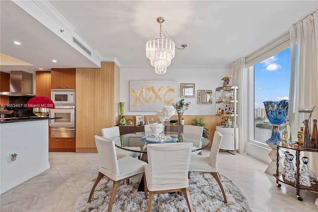 dining area featuring ornamental molding, light tile patterned floors, and a notable chandelier