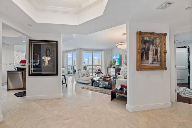 hall featuring crown molding and a tray ceiling