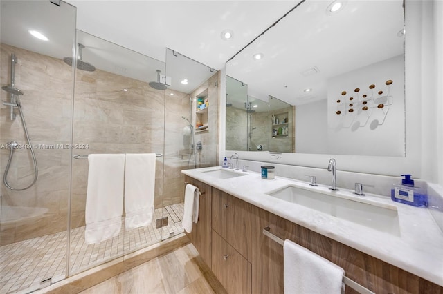 bathroom with a shower with door and vanity