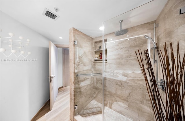 bathroom featuring a chandelier and walk in shower