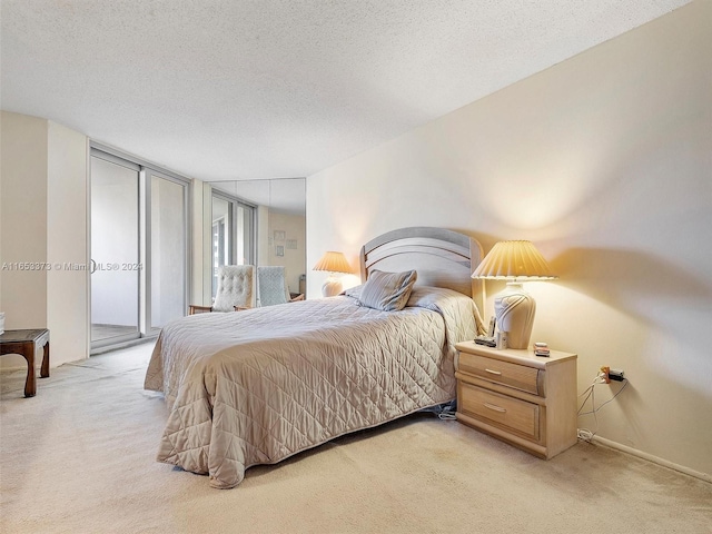 bedroom featuring a textured ceiling, carpet flooring, and access to exterior