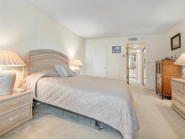 carpeted bedroom featuring a textured ceiling