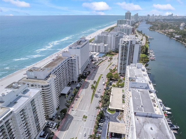 drone / aerial view featuring a view of the beach and a water view