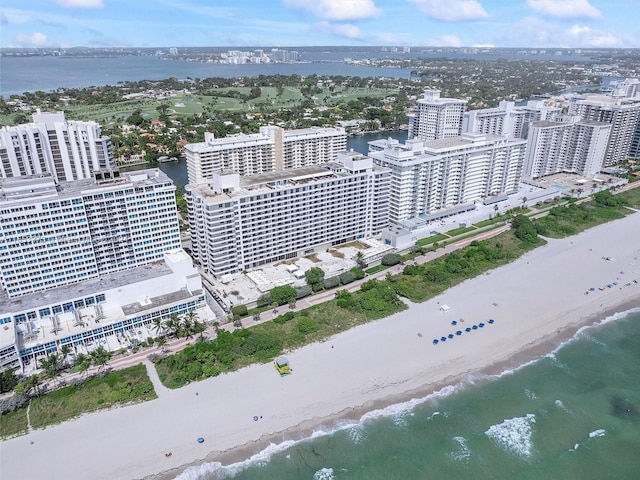 birds eye view of property with a beach view and a water view