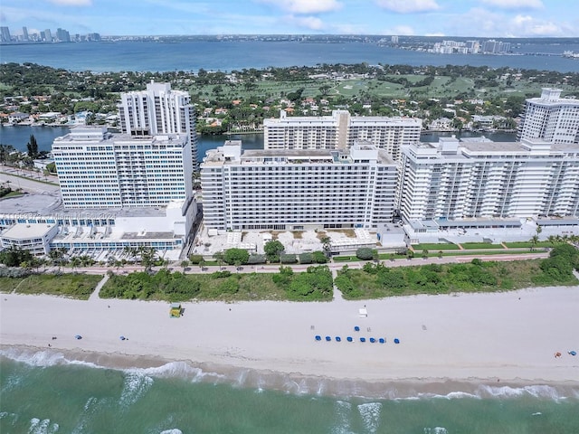 birds eye view of property with a water view and a view of the beach