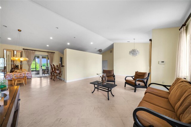 living room featuring vaulted ceiling and a chandelier