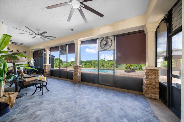 sunroom featuring ceiling fan