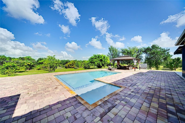 view of swimming pool featuring a patio and a gazebo