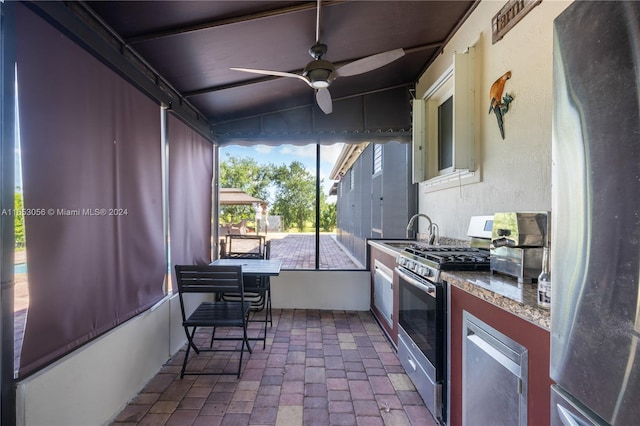 exterior space featuring exterior kitchen, ceiling fan, sink, and wine cooler