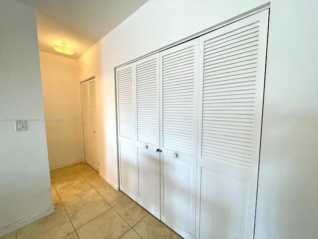 corridor with light tile patterned floors