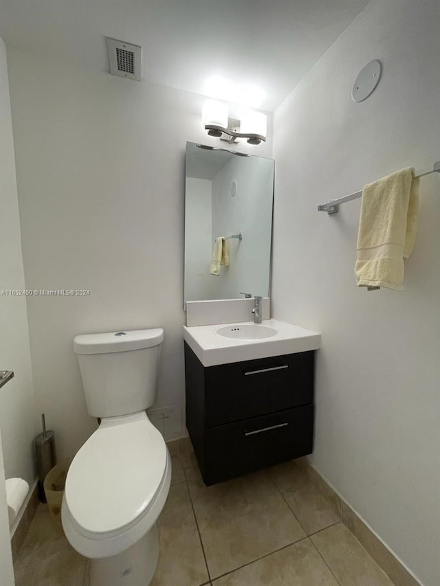 bathroom featuring vanity, toilet, and tile patterned flooring