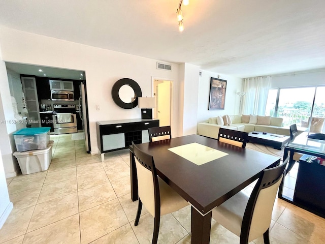 dining space featuring light tile patterned flooring