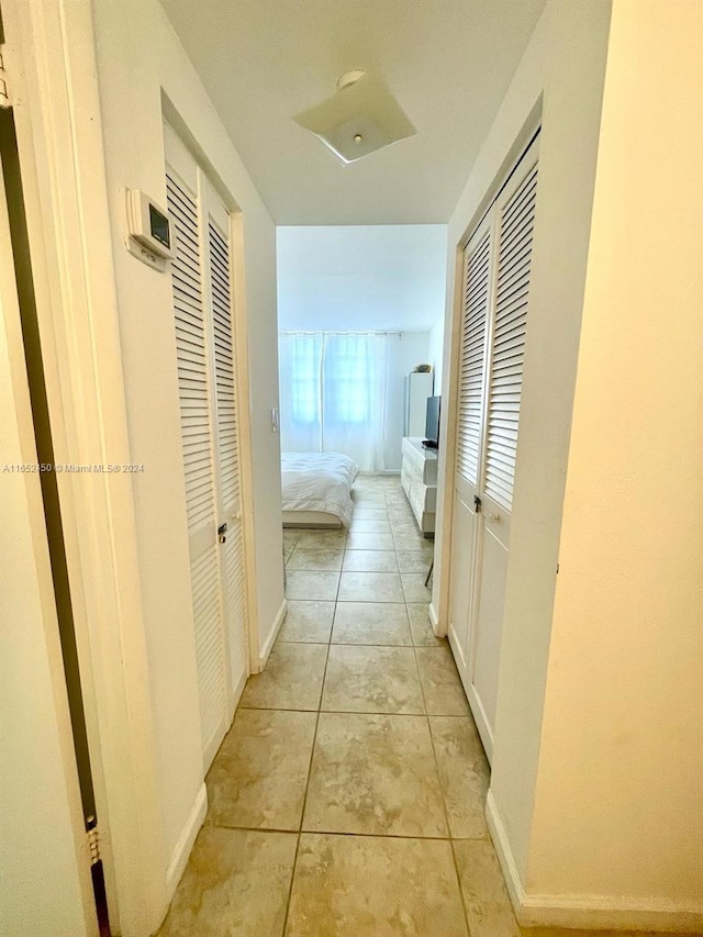 hallway featuring light tile patterned floors