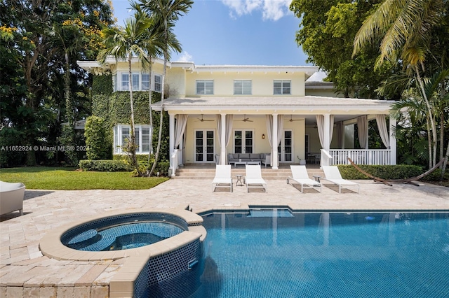 rear view of house with french doors, cooling unit, ceiling fan, a swimming pool with hot tub, and a patio