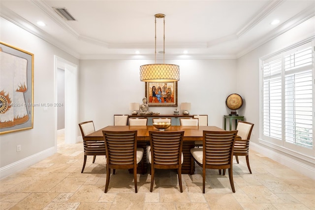 dining room with ornamental molding and a tray ceiling